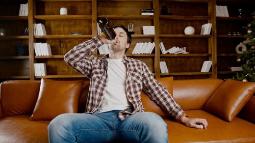 Alcohol addiction at young age. Caucasian male cannot stop drinking alcohol, drunken lonely male