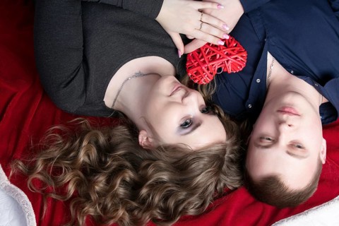 Couple in love from top to bottom. Man and woman with a red heart. Beautiful young man and woman