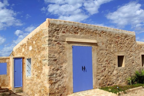 Stone house masonry blue sky door windows Formentera Balearic