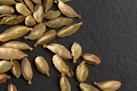 Cardamom pods on black background macro closeup