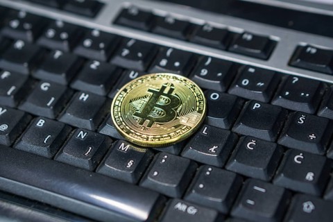 Background with bitcoin on the keyboard