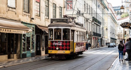 Lisbon, Portugal, 12 28 2018: Typical tramway driving in downtown Bairro Chiado in the steep narrow