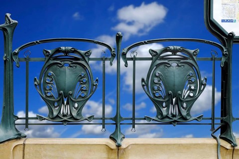 Railing of a Paris metro station with typical floral Art Nouveau elements. Landscape format.