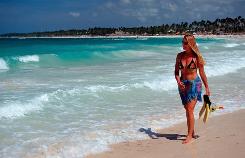 Woman strolling on a sandy beach, Catalina Island, Caribbean, Dominican Republic, Central America