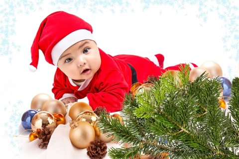 Baby in Santa costume. Christmas tree isolated on white