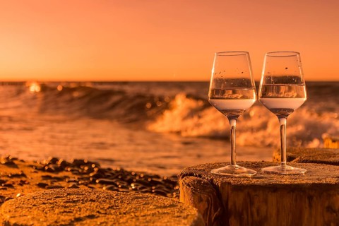 Wine on the baltic sea beach at sunset