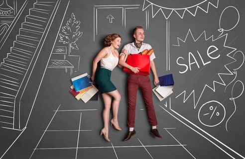 Love story concept of romantic couple shopping against chalk drawings background. Young happy