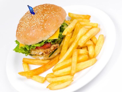 A cheeseburger with deep fried potatoes, closeup