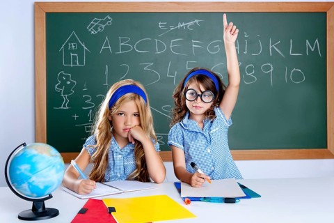 Smart nerd student in classroom raising hand with sad friend
