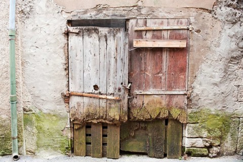 Very old wooden rotten doors in French building