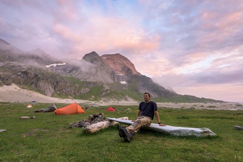 Man resting by the tent, Buneset, Moskenesöya, Lofoten, Nordland, Norway, July 2015, Europe