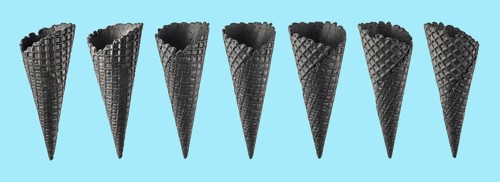 Various ice cream cones isolated on blue background. Various perspective of black waffle sugar