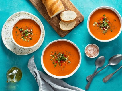 Gaspacho soup on blue tabletop. Three bowls of traditional spanish cold soup puree gaspacho or