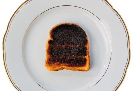 Toast was burnt during toasting. Burnt slices of toast at breakfast. Austria