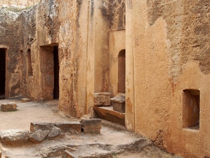 Tomb doors and niches in a carved sandstone wall forming a street like view in the temple of the