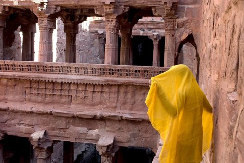 Man with yellow cloth standing at old stepwell tapi baori, Jodhpur, Rajasthan, India, Asia