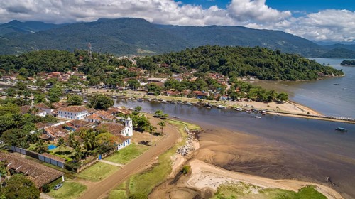 Aerial view to historic town Paraty, tidal river and Jabaquara with green mountains in background