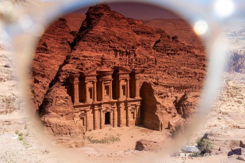 View on the monastery of Petra through the tainted glass of a sunglasses. Creative image