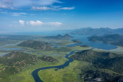 Aerial view of Rijeka Crnojevica, beautiful river between mountains flowing into Skadar Lake,