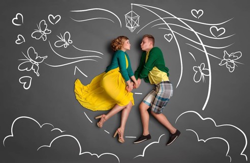 Happy valentines love story concept of a romantic couple sitting on the moon, holding hands and