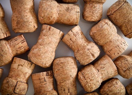 Dated wine bottle corks on the wooden background. Close up