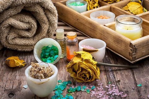 Sea aromatic salt for Spa treatments on the background of yellow rose buds