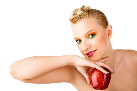 Beauty woman with red apple in the hand