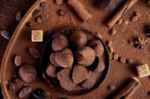Healthy delicious chocolate truffles around ingridients with natural cocoa beans, powder, cacao