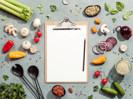 Food ingredients, salad serving utensils and clipboard with white paper sheet. Various of