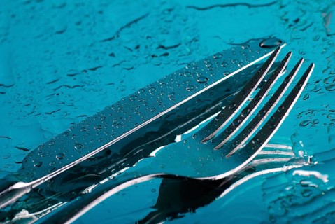 Fork and knife under the blue water