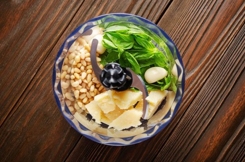 Ingredients for italian national traditional genovese pesto sauce in food processor bowl. Flat lay