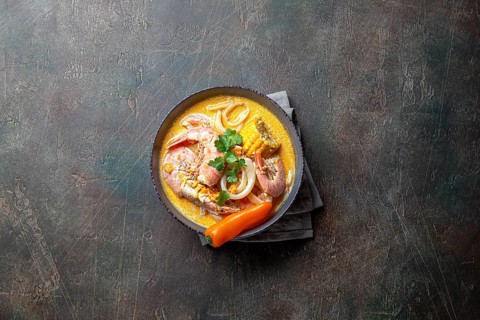 Food, Peruvian seafood soup Chupe de Camarones in gray bowl, top view