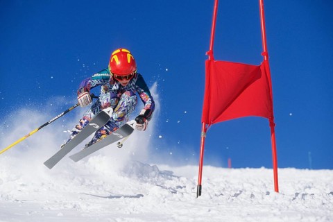 Skiers in action, descent on a slope, deep snow