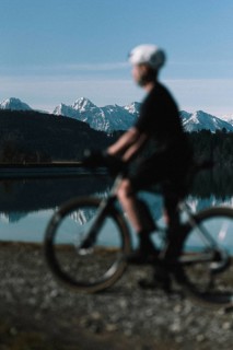 Road bike rider in spring near Halblech in the Allgäu in front of a picturesque backdrop of the