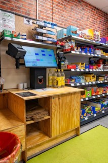 Digital checkout and shelves full of products in a modern supermarket, Tante M, self-service shop,