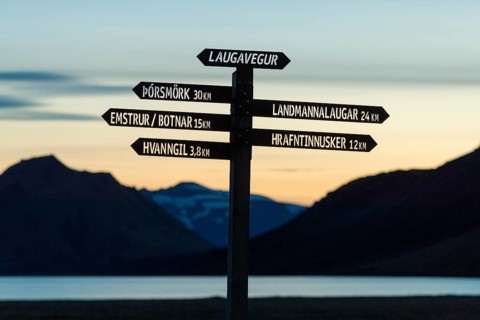 Signpost for hikers stands out against the evening sky, Laugavegur, Iceland's most famous hiking