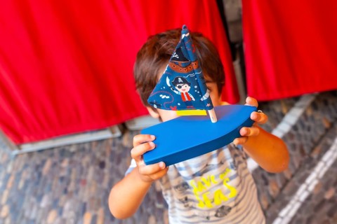 A boy with a play boat on the Freiburg im Breisgau canal, Germany, Europe