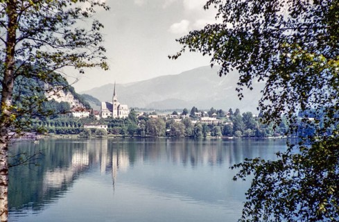 View over water of to church of Saint Martin and town, Lake Bled, Bled, Slovenia, former