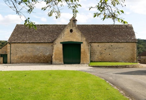 Historic nineteenth century farmyard stone barn building, Yanworth, Gloucestershire, England, UK