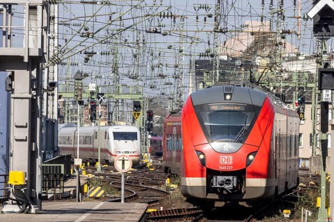 Central station with track apron, rails and overhead lines. ICE and regional train of Deutsche Bahn