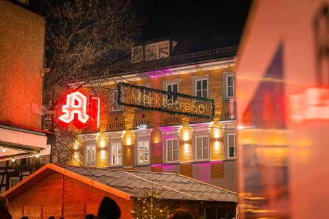 An illuminated pharmacy and the market street at night, Lichternacht Fest, Nagold, Black Forest,