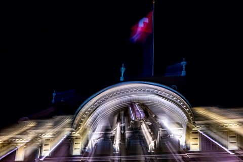 Beautiful Illuminated Swiss National Bank and Swiss Flag at Night in City of Bern, Bern Canton,
