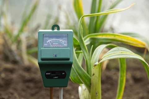 The meter has various indications illustrating its role in monitoring and measuring the moisture