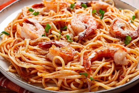 Spaghetti with tiger prawns, in tomato sauce, homemade, top view, no people