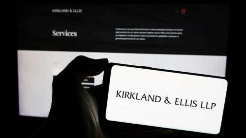 Stuttgart, Germany, 12-15-2023: Person holding mobile phone with logo of American law firm Kirkland