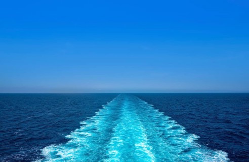 Boat wake ferry cruise wash foam in blue ocean sea