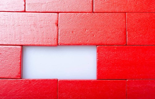 Red color domino blocks placed on a white background