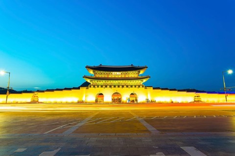 Long exposure car lights leaving a straight light trail in front of Gwanghwamun main entrance gate