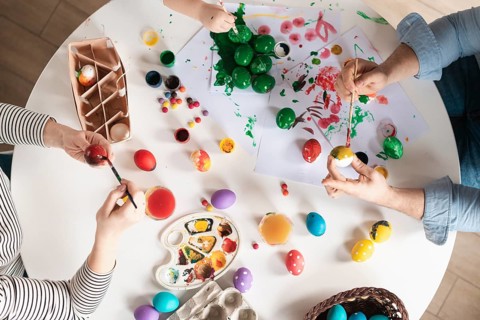 Top view family painting eggs easter