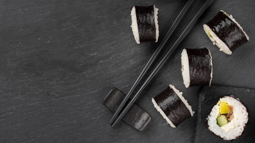 Sushi rolls with chopsticks copy space